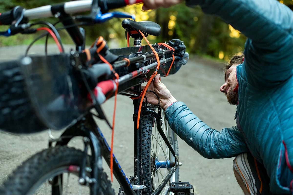 Using ski straps to attach skis to a bike (close up)