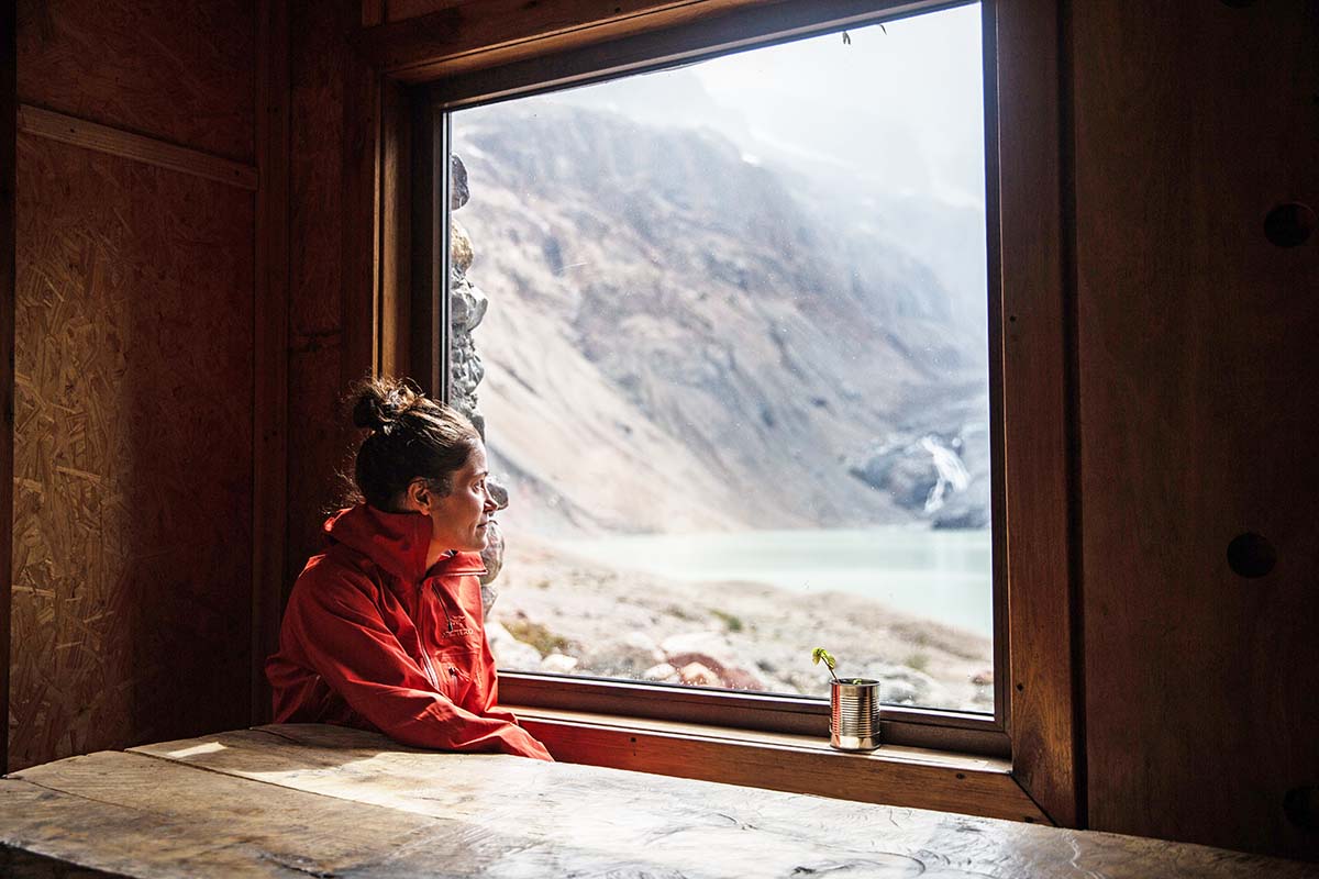 Sasha looking out window at Refugio Puesto Cagliero