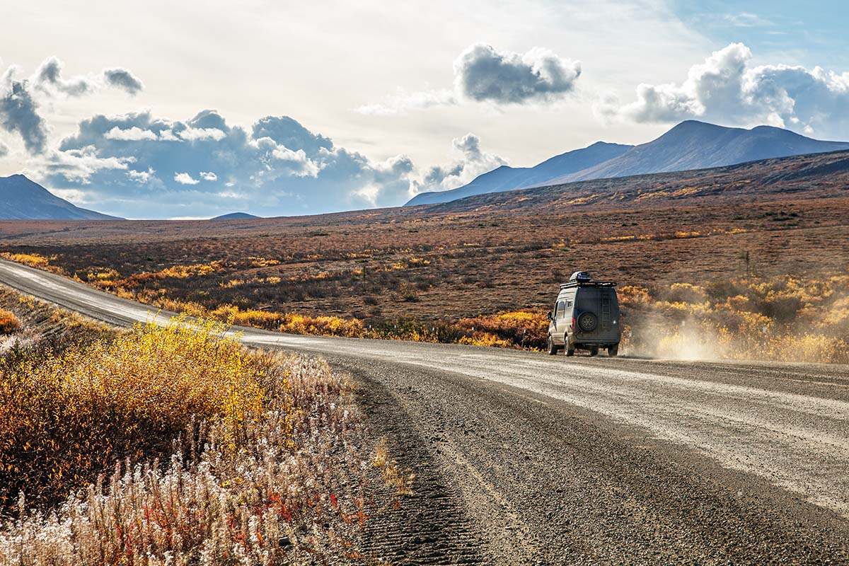 Driving Sprinter Van down dirt road in fall