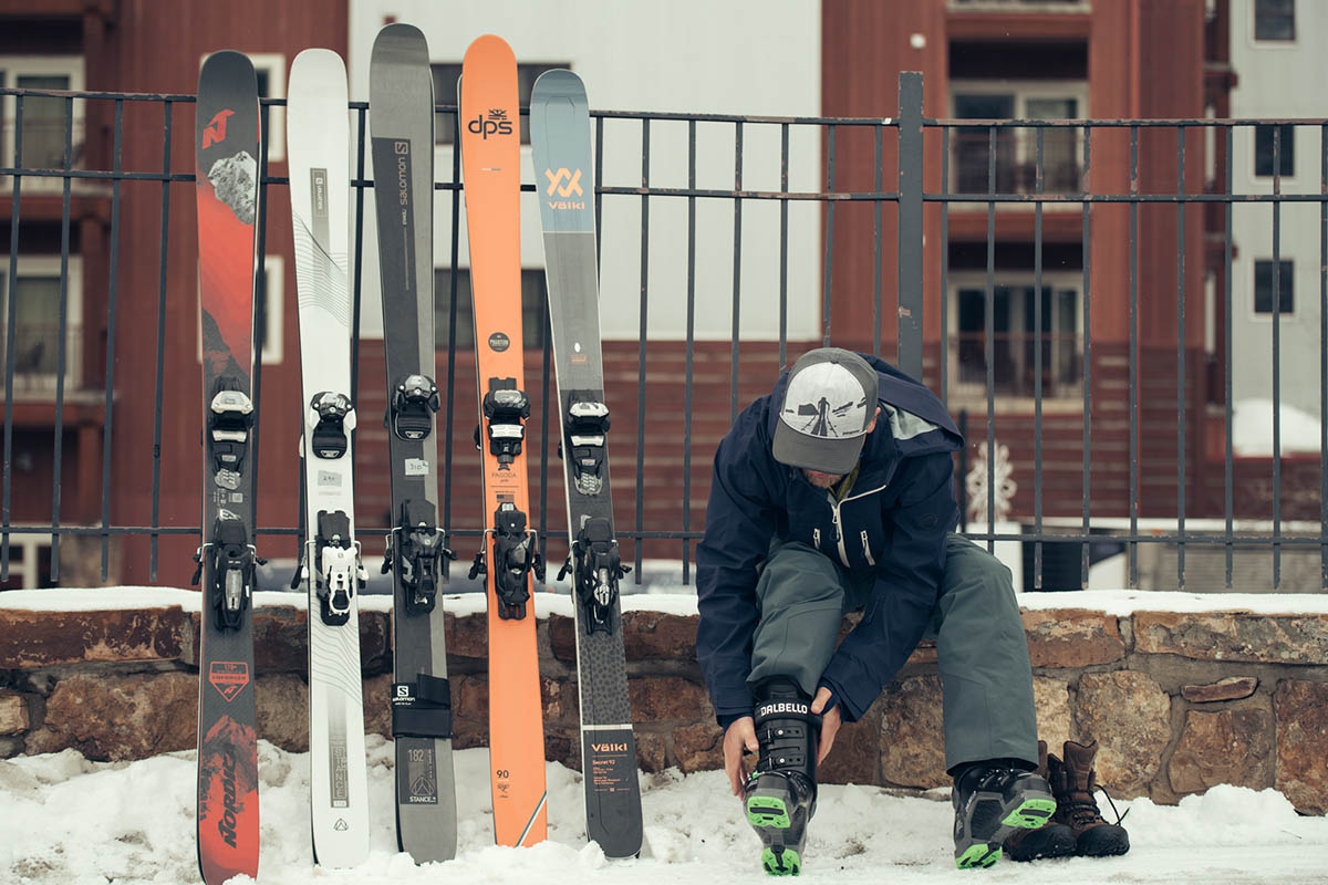 All-mountain skis (lined up against fence)