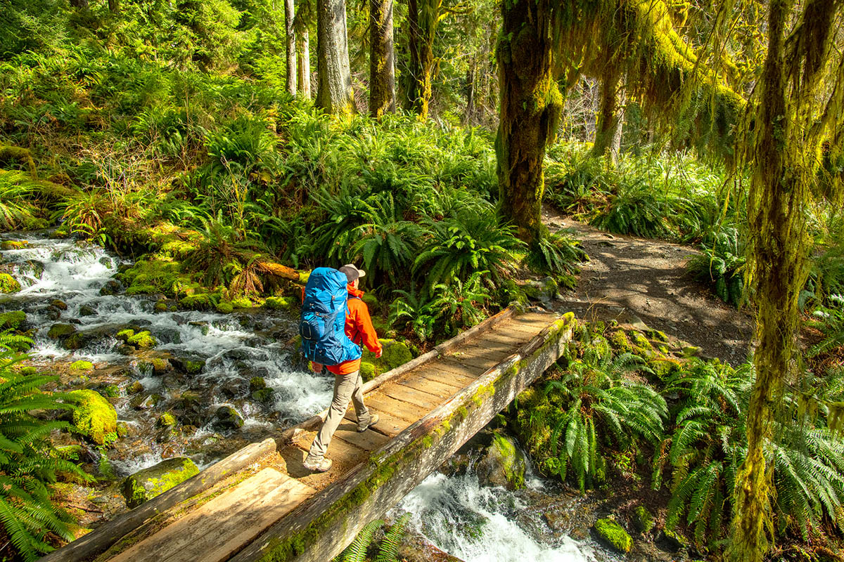 Hiking over bridge in Hoh Rainforest (Osprey Aether 65 backpacking pack)