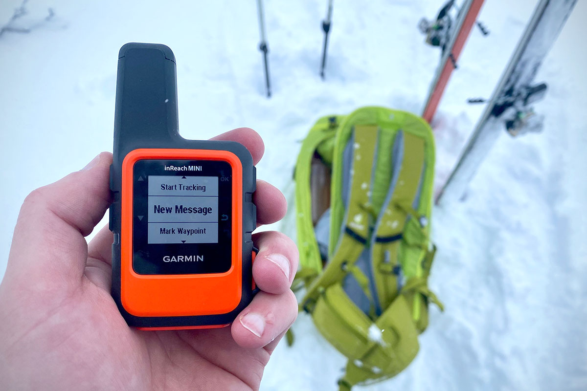 Holding the Garmin inReach Mini satellite messenger