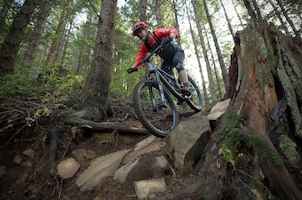 The Santa Cruz Bronson mountain bike coming downhill over some rocks