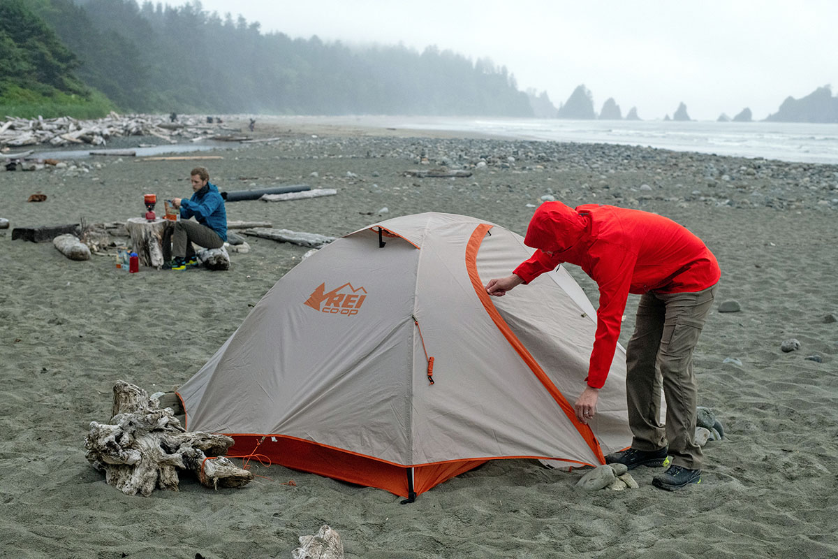 Zipping up REI Co-op Passage 2 budget backpacking tent (camping on beach)