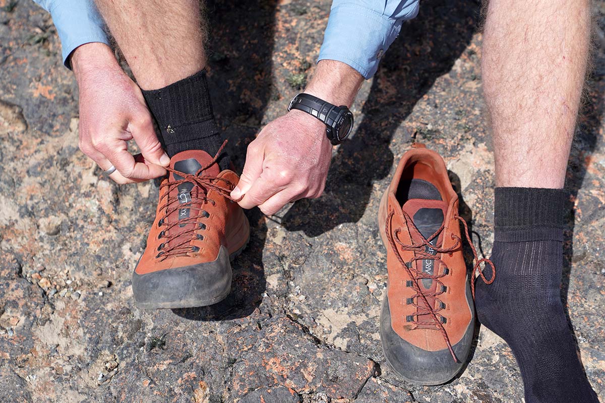 Arc'teryx Konseal AR approach shoe (lacing up on rock)