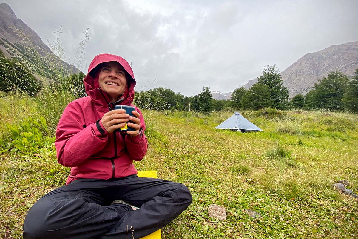 Black Diamond Liquid Point rain jacket (sitting beside tent in field)