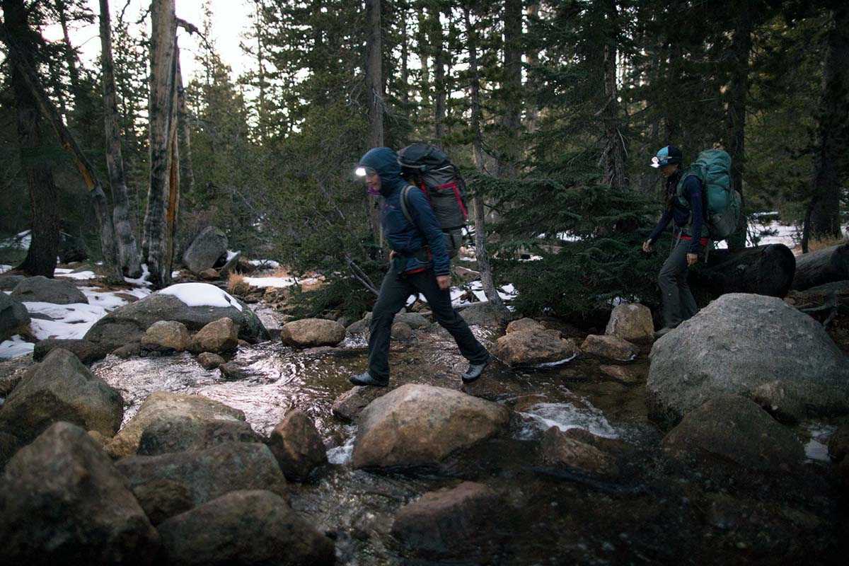 Wearing headlamps crossing stream