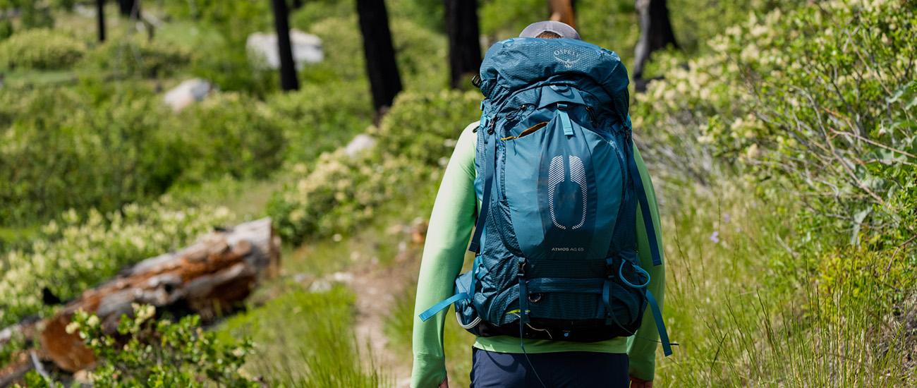 Osprey Atmos AG 65 backpacking pack (hiking through forest)
