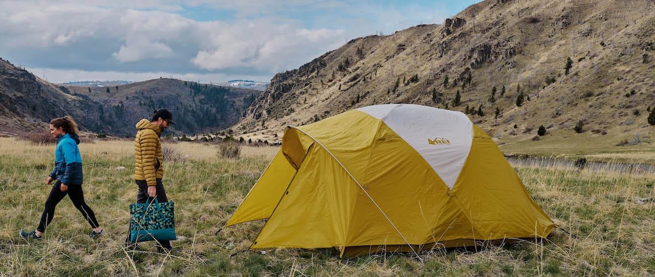 Setting up the Base Camp 6 tent in a field in the Montana wilderness