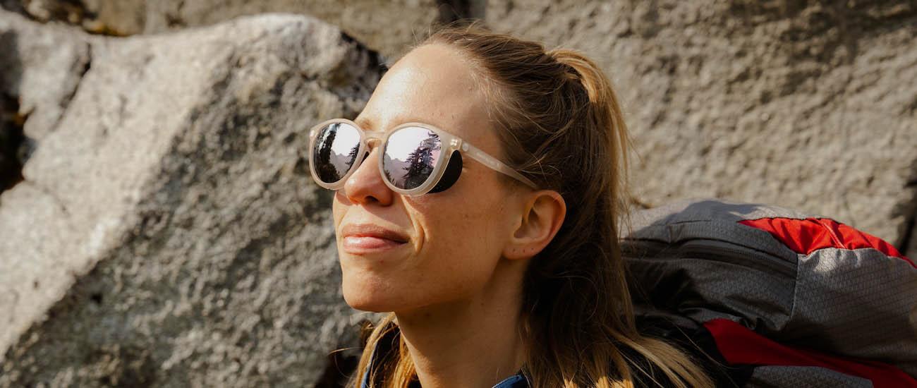 A woman wearing sunglasses with wings for peripheral protection