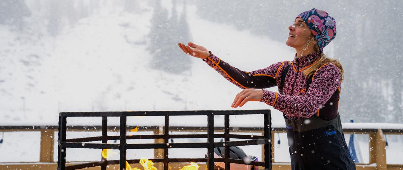 Women's baselayer (standing by fire at lodge in Kari Traa Rose Half-Zip)