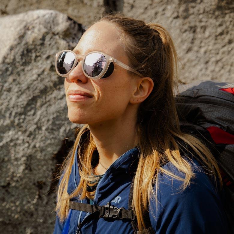 A woman wearing sunglasses with wings for peripheral protection