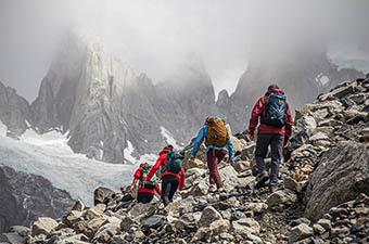 Hiking daypacks (group hiking toward mountains)