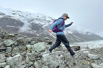 A women hiking in Alaska in the REI Co-op XeroCloud 3L jacket