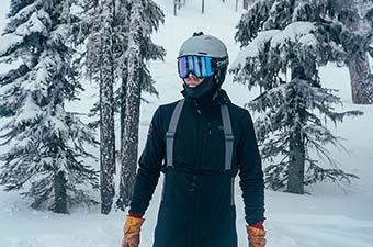 REI First Chair GTX Bibs (standing in snowy forest)