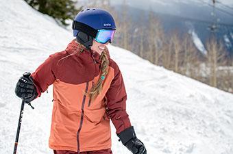 Women's ski jacket (smiling wearing Outdoor Research Tungsten at resort)