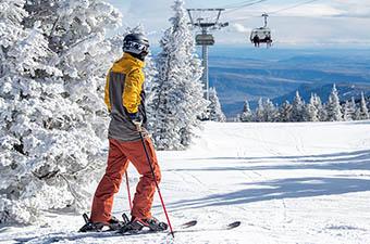 View of snow-covered trees and ski chairlift